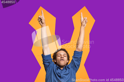 Image of Winning success man happy ecstatic celebrating being a winner. Dynamic energetic image of male model