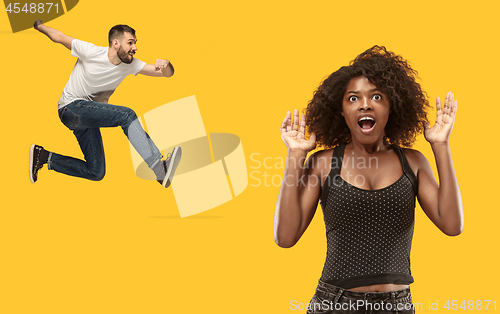 Image of Beautiful woman looking suprised and running and jumping man