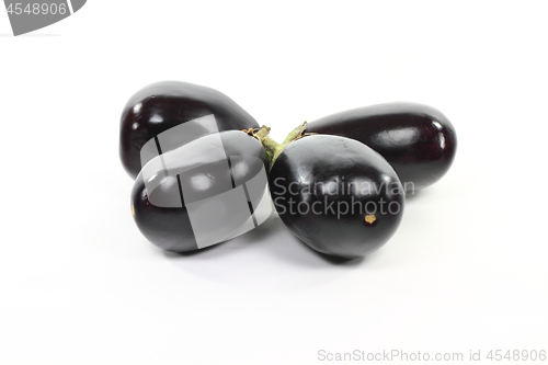 Image of Pile Italian Baby Eggplants on white. 