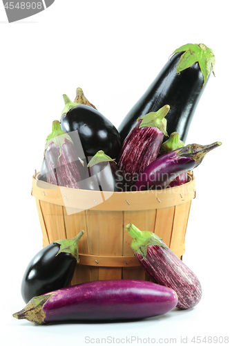 Image of Assorted Eggplants in Bushel Basket on white. 