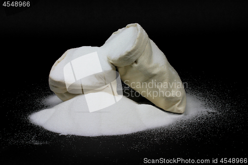 Image of Spill Natural Granulated Sugar from bags on black 