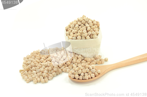 Image of Chick Peas on pile, in wooden spoon, in fabric bag 