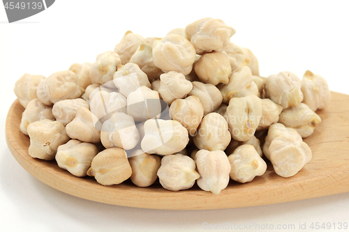 Image of Chick Peas on pile, in wooden cooking spoon. 