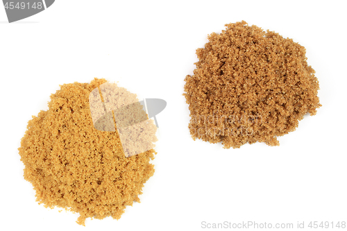 Image of Two types brown sugar on pails. 