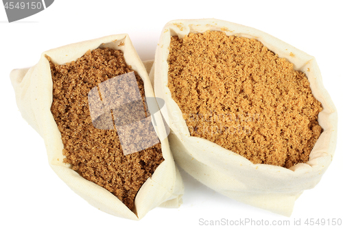 Image of Two types brown sugar in white fabric bags. 