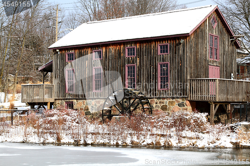 Image of Old water mill in Waterloo, Ontario in snowy day.