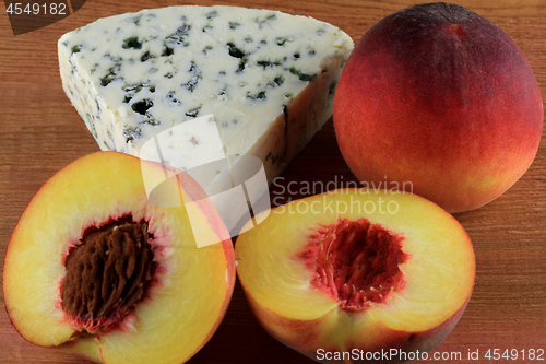 Image of Blue Cheese served with Cut Peaches. 