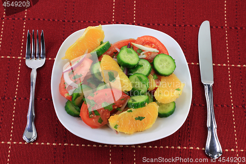 Image of Served in dish, fruits and vegetables salad. 