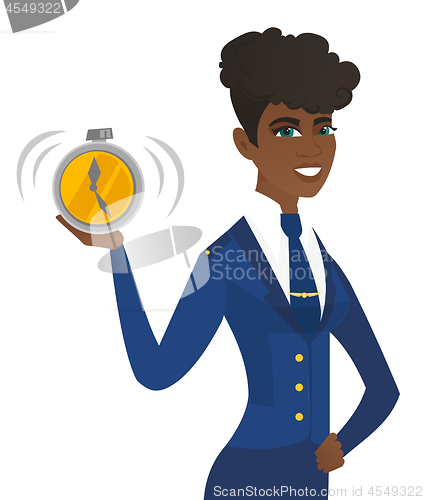 Image of Arican-american stewardess holding alarm clock.