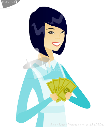 Image of Young asian cleaner holding money.