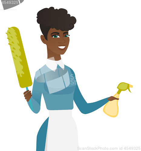 Image of African housemaid holding spray bottle and duster.