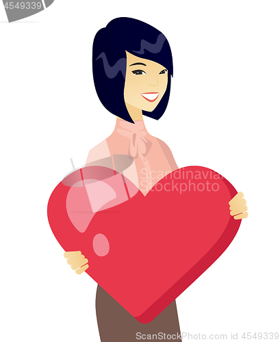 Image of Young asian business woman holding a big heart.