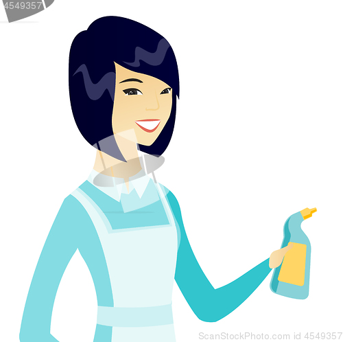Image of Young asian cleaner in uniform holding detergent.