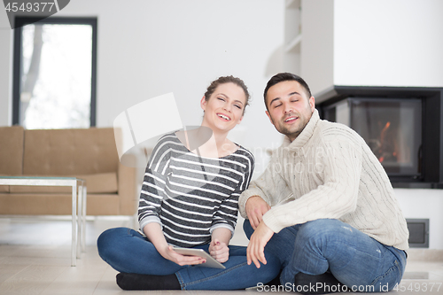 Image of Young Couple using digital tablet on cold winter day