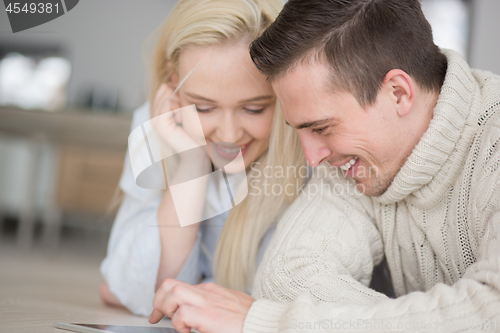 Image of Young Couple using digital tablet on cold winter day