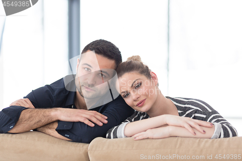 Image of Portrait of young couple sitting on sofa