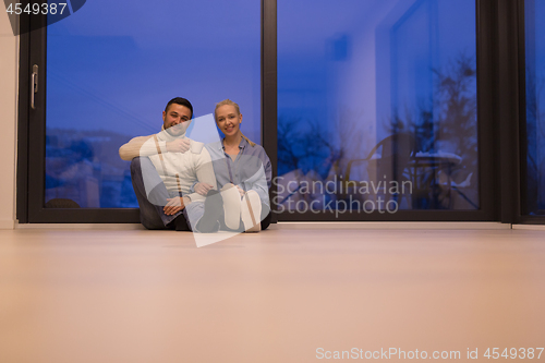 Image of happy couple in front of fireplace