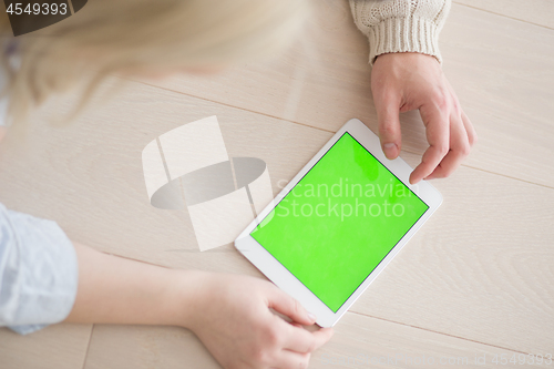 Image of Young Couple using digital tablet on cold winter day