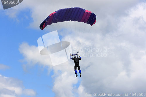 Image of Skydiver parachuting down to the Earth. 