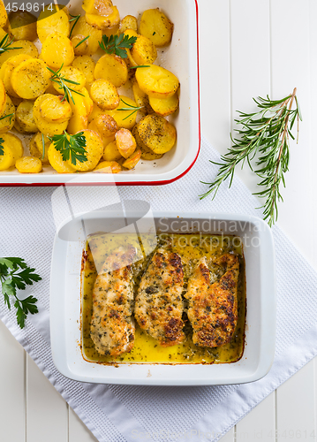 Image of Chicken parmigiana - parmesan chicken with baked potatos 