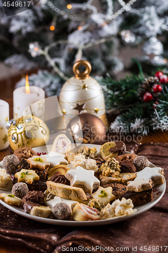 Image of Assorted Christmas cookies with candles on the table