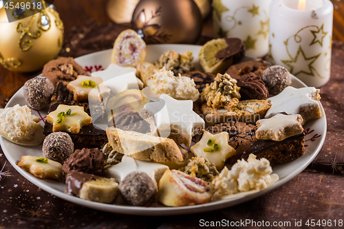 Image of Assorted Christmas cookies with candles on the table