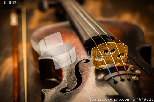 Image of Detail of old violin and bow in vintage style