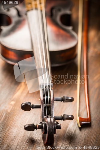 Image of Detail of old violin and bow in vintage style