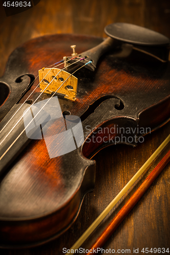 Image of Detail of old violin and bow in vintage style