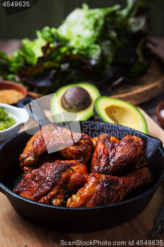 Image of Grilled hot and spicy chicken wings with guacamole