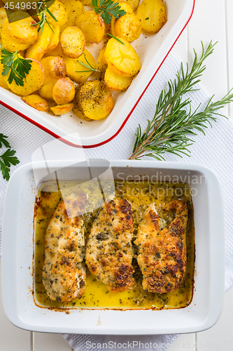 Image of Chicken parmigiana - parmesan chicken with baked potatos 