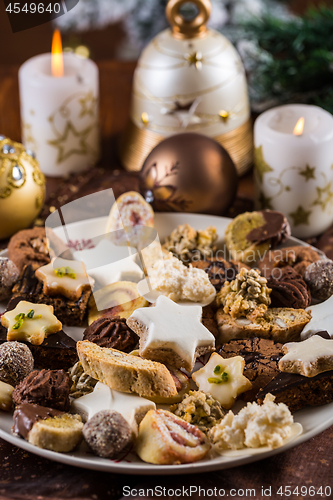 Image of Assorted Christmas cookies with candles on the table