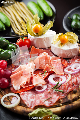 Image of Serrano ham platter with variation of appetizers