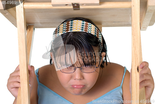 Image of Girl Hiding Under Table