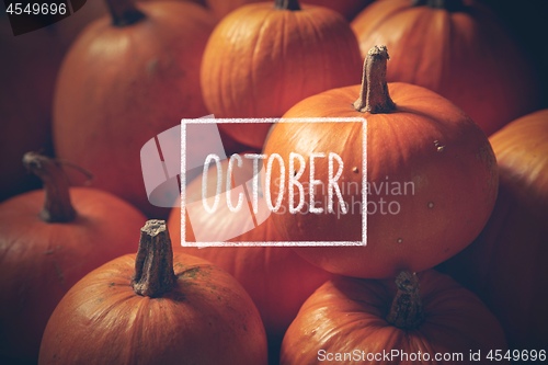 Image of pumpkins with hand drawn chalk text October