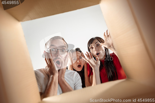 Image of The people unpacking and opening carton box and looking inside