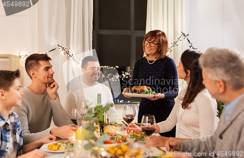 Image of happy family having dinner party at home