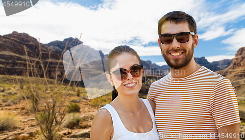 Image of couple in sunglasses in summer over grand canyon