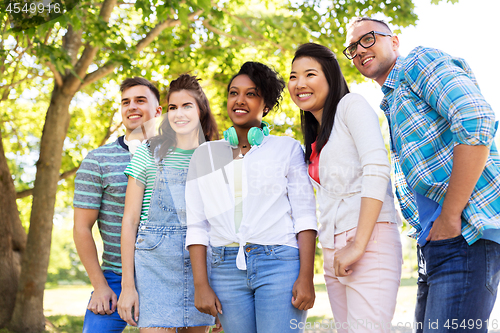 Image of happy international friends in park