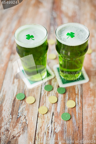 Image of glasses of green beer with shamrock and gold coins
