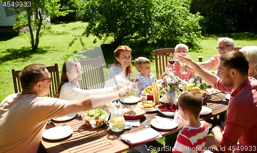 Image of happy family having dinner or summer garden party