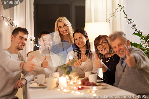 Image of happy family having tea party at home