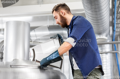 Image of man working at craft brewery or beer plant