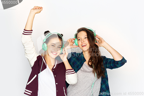 Image of teenage girls in earphones listening to music