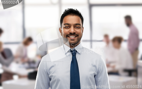 Image of indian businessman in shirt with tie over office