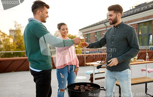 Image of friends toast drinks at barbecue party on rooftop