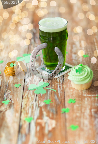 Image of glass of beer, cupcake, horseshoe and gold coins