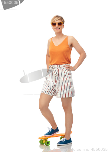 Image of smiling teenage girl with skateboard over white