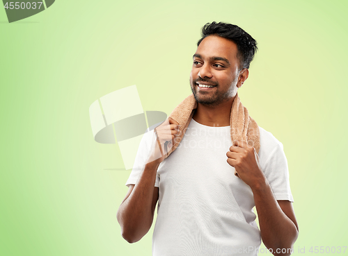 Image of smiling indian man with towel over green 