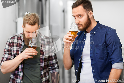 Image of men drinking and testing craft beer at brewery